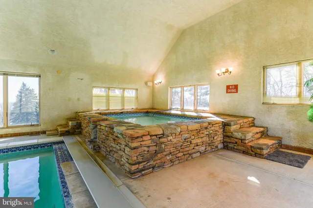 an aerial view of a house with a yard basket ball court and outdoor seating