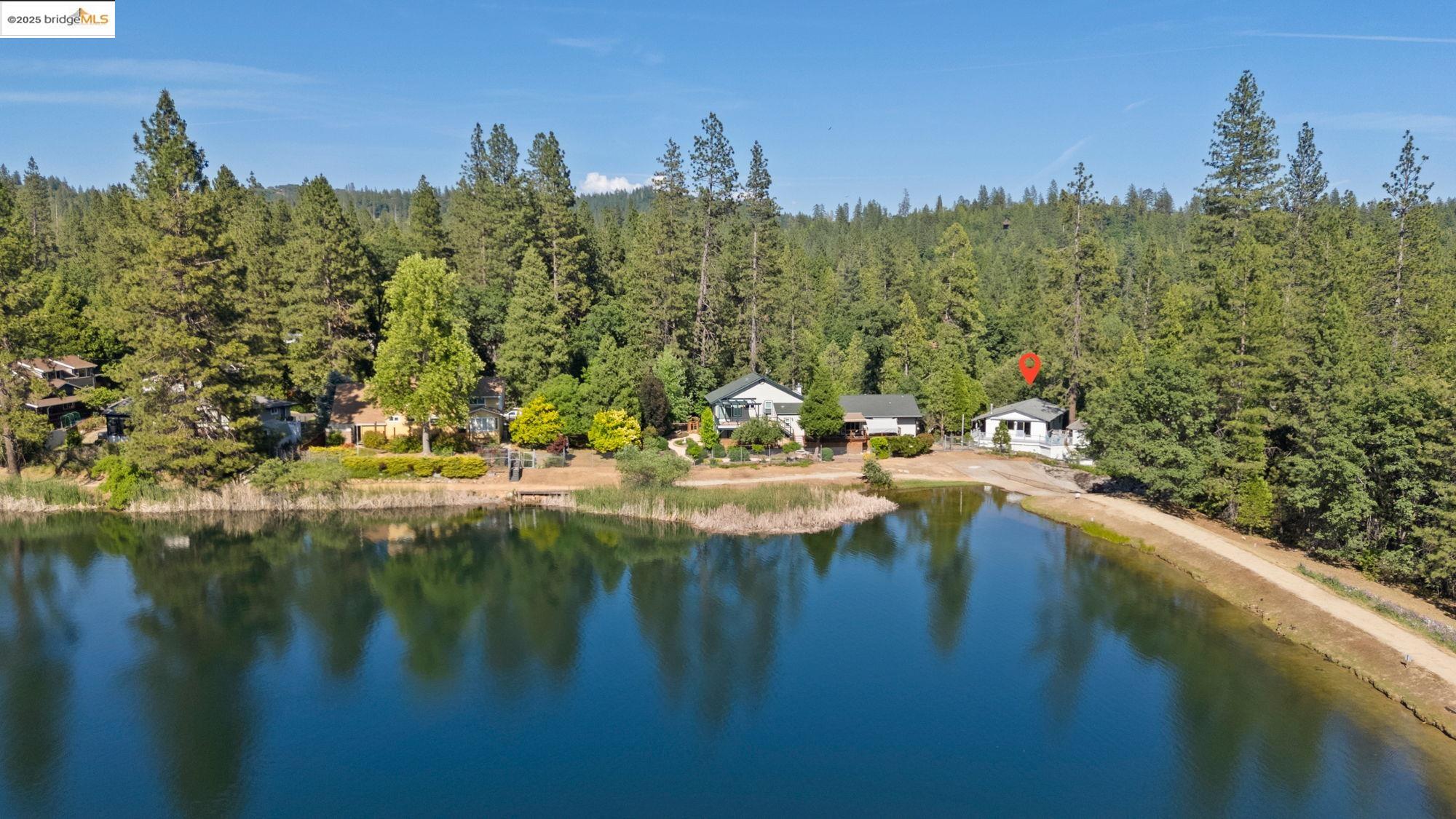22970 South Fork Road Twain Harte, CA 95383 - Photo 1 of 1 a view of a lake with a mountain in the background