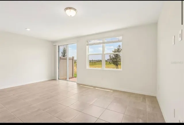 a view of kitchen with kitchen island and stainless steel appliances