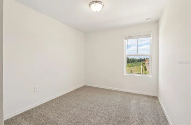 a view of an empty room and a window