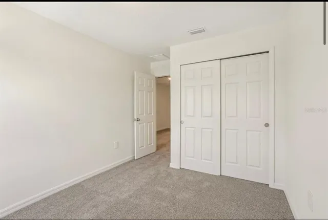a white toilet sitting next to a white wall