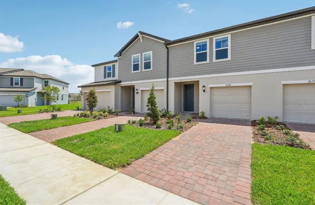 a front view of a house with a yard and garage