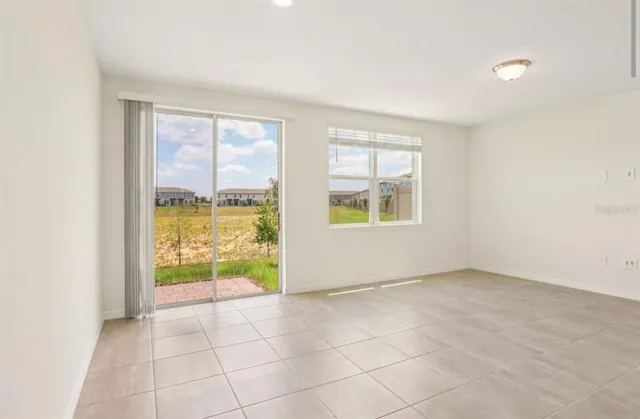 an empty room with entrance and windows