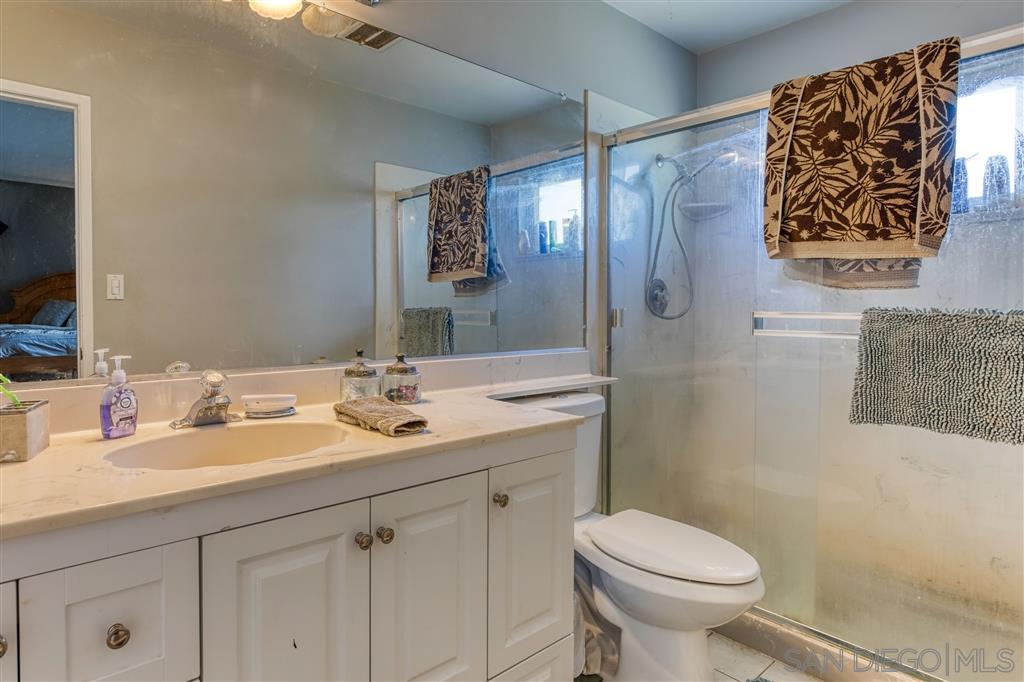1906 Tavern Road Alpine, CA 91901 - Photo 14 of 16 a bathroom with a granite countertop toilet sink and mirror