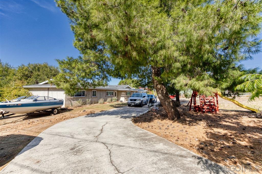 1906 Tavern Road Alpine, CA 91901 - Photo 2 of 16 a view of a street with trees on both side of it