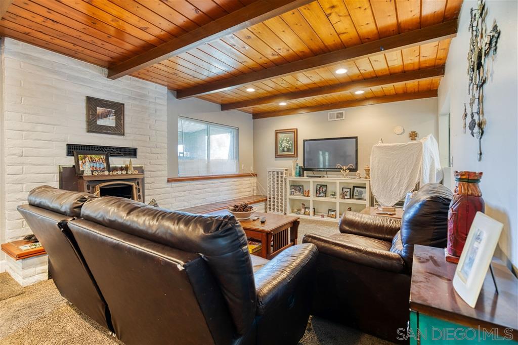 1906 Tavern Road Alpine, CA 91901 - Photo 3 of 16 a living room with furniture a fireplace and a flat screen tv