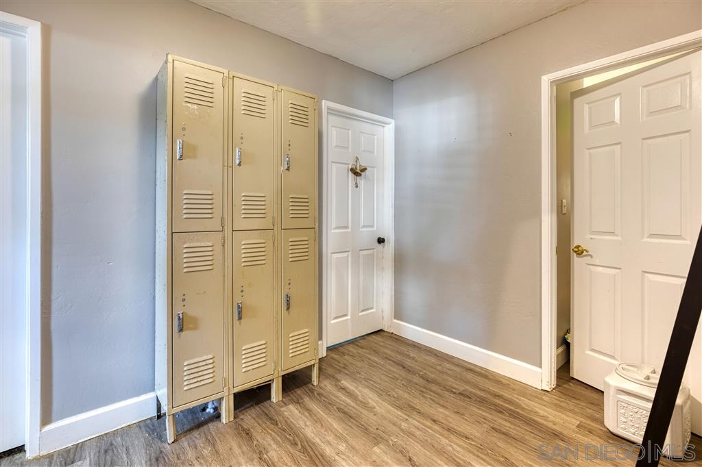 1906 Tavern Road Alpine, CA 91901 - Photo 8 of 16 an empty room with wooden floor and entrance