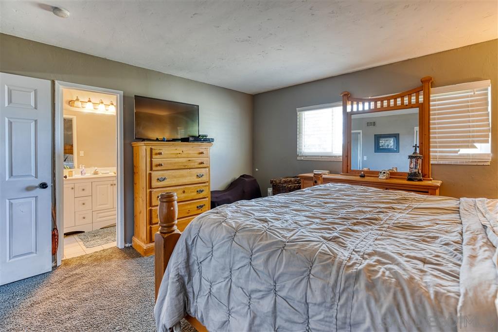 1906 Tavern Road Alpine, CA 91901 - Photo 9 of 16 a bedroom with a bed and a television