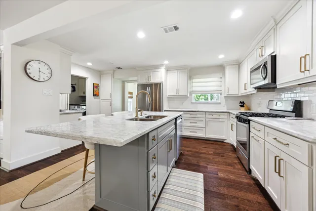 a kitchen with granite countertop counter space a sink appliances and cabinets