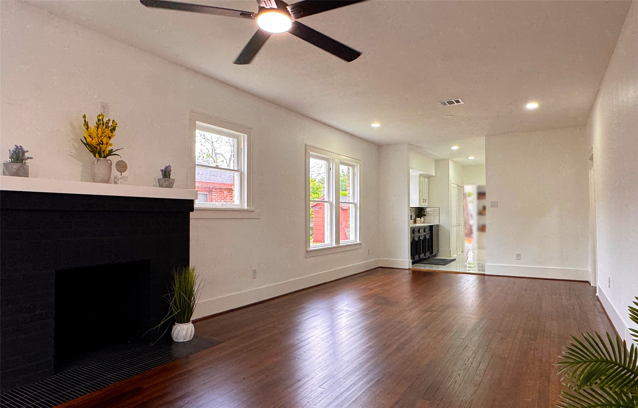 1569 Elliott Street Houston, TX 77023 - Photo 2 of 14 a view of an empty room with wooden floor and a window