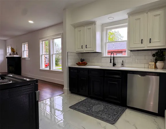 a kitchen with a sink stove and cabinets