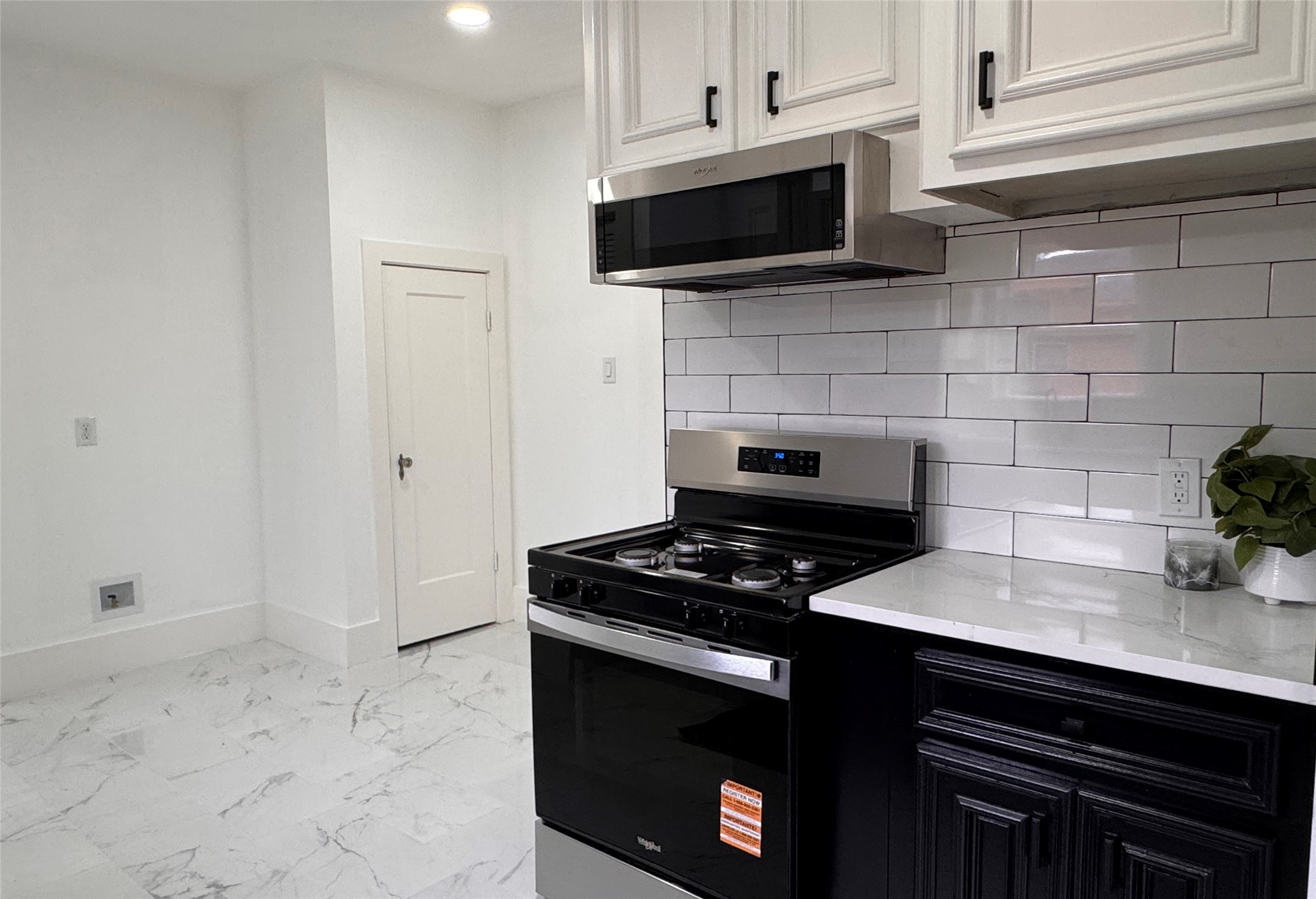 1569 Elliott Street Houston, TX 77023 - Photo 6 of 14 a kitchen with a stove and a microwave
