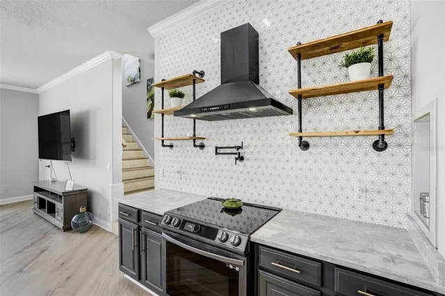 a kitchen with granite countertop a stove and a sink
