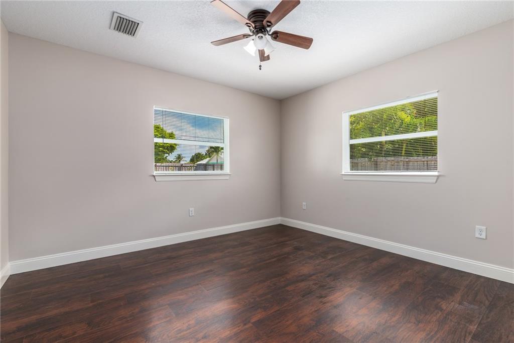 5111 Southeast Post Terrace Stuart, FL 34997 - Photo 17 of 34 a view of an empty room with wooden floor and a window