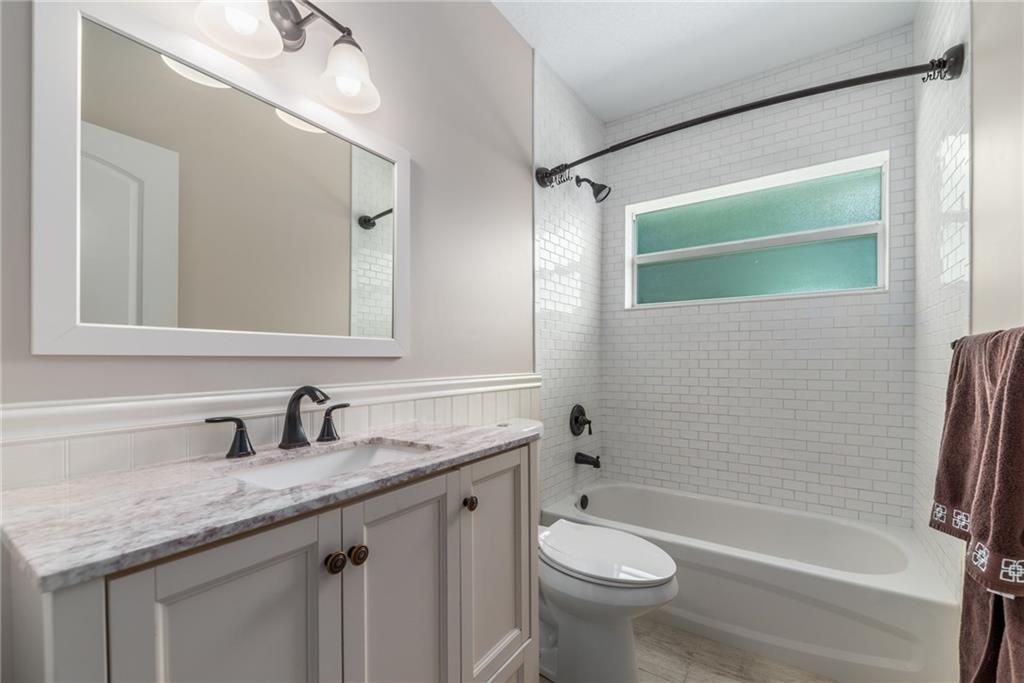 5111 Southeast Post Terrace Stuart, FL 34997 - Photo 18 of 34 a bathroom with a granite countertop sink toilet and shower