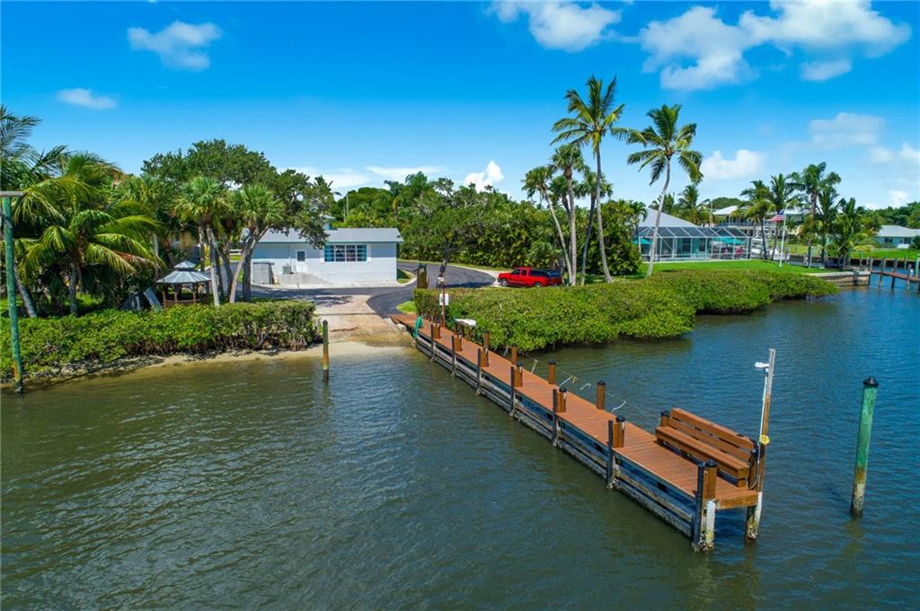 5111 Southeast Post Terrace Stuart, FL 34997 - Photo 3 of 34 a view of a lake with houses