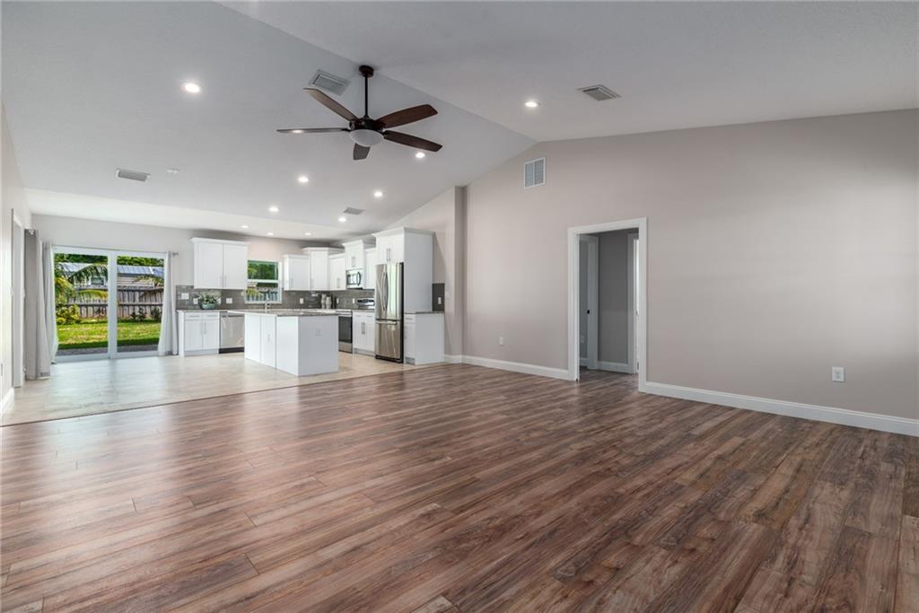 5111 Southeast Post Terrace Stuart, FL 34997 - Photo 9 of 34 an empty room with wooden floor and windows