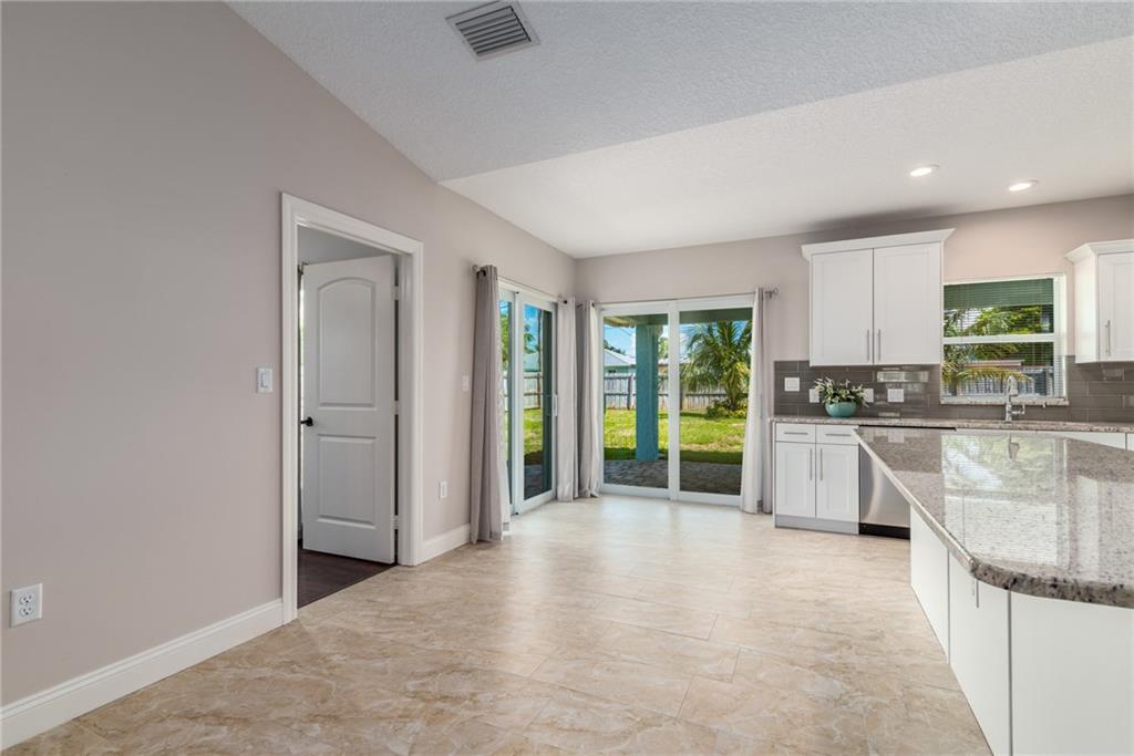 5111 Southeast Post Terrace Stuart, FL 34997 - Photo 10 of 34 a view of a kitchen with a sink and a large window