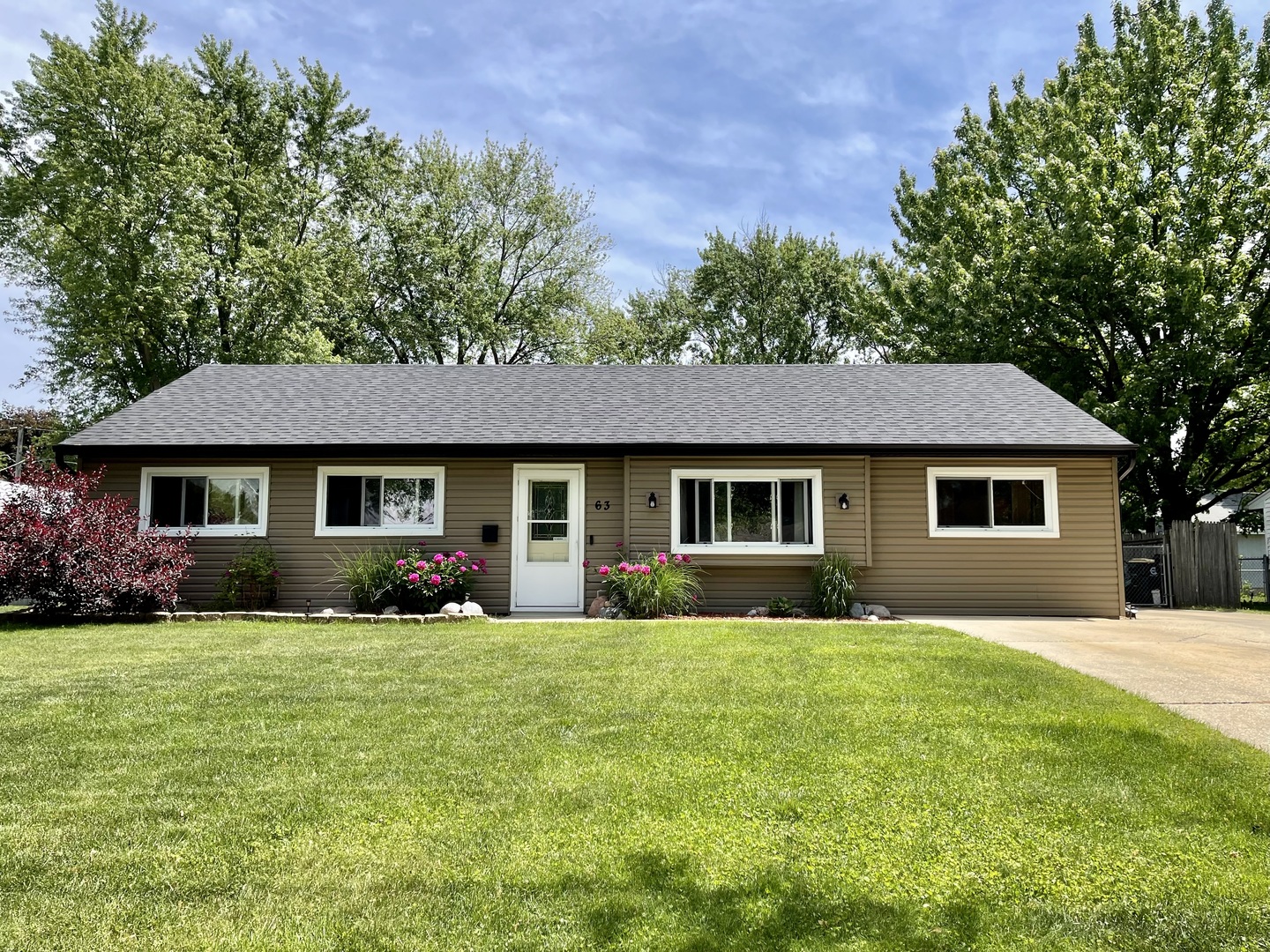 63 Stratford Road Montgomery, IL 60538 - Photo 1 of 24 a front view of a house with yard and trees
