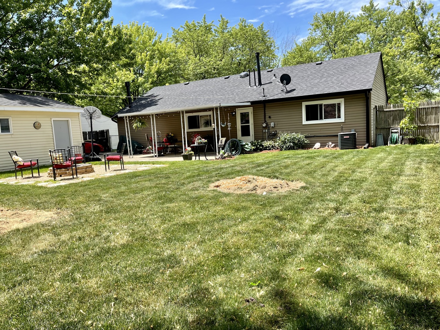 63 Stratford Road Montgomery, IL 60538 - Photo 19 of 24 a front view of a house with a garden and trees