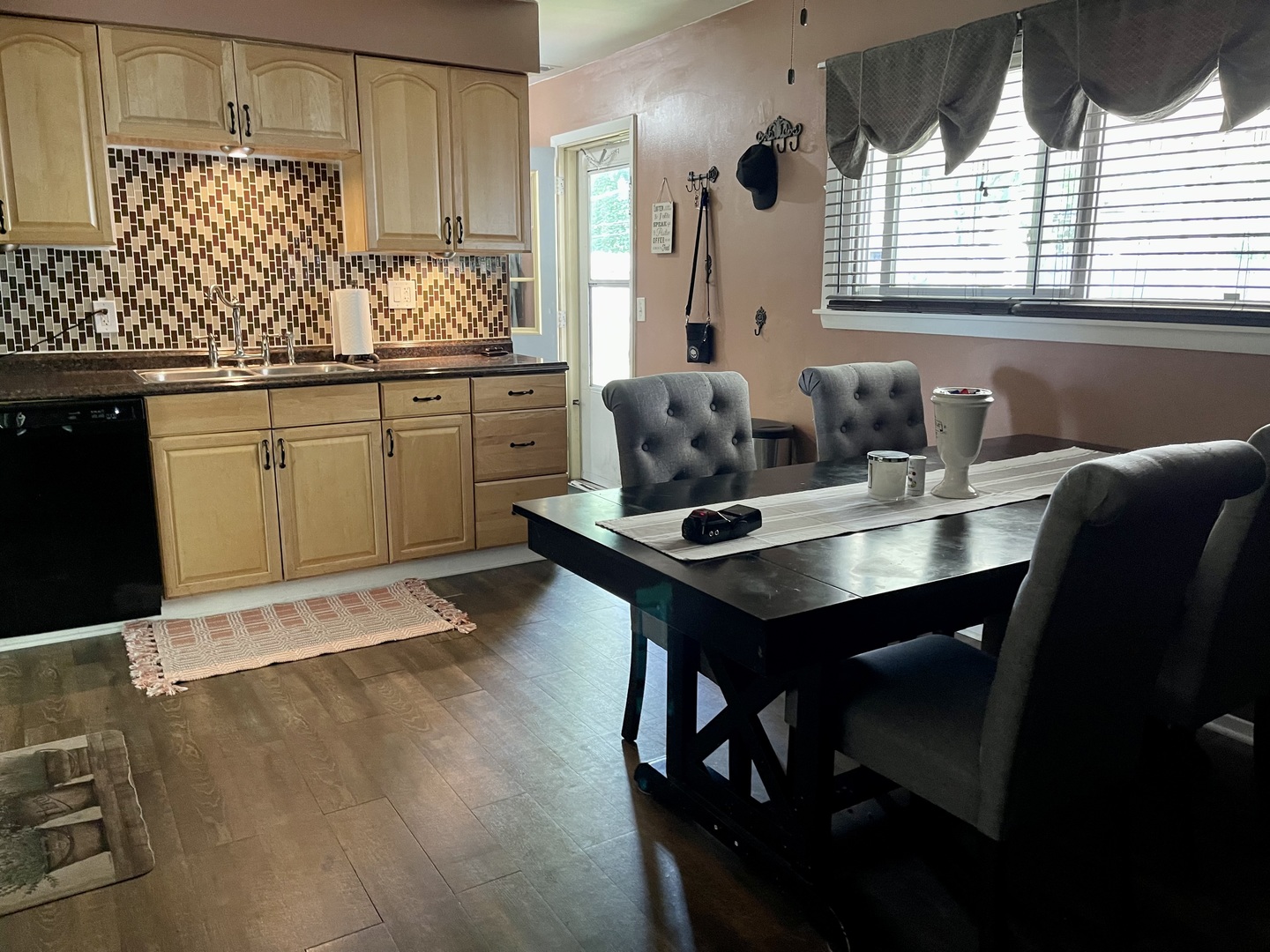 63 Stratford Road Montgomery, IL 60538 - Photo 7 of 24 a kitchen with kitchen island granite countertop a sink cabinets and wooden floor