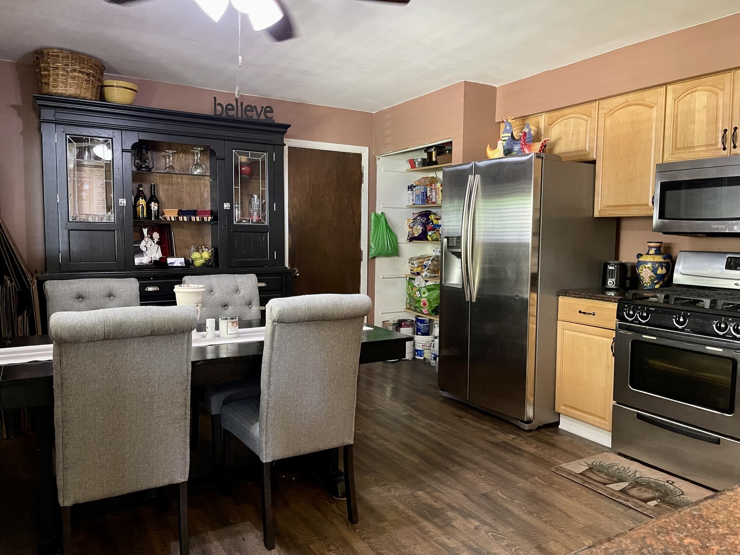 63 Stratford Road Montgomery, IL 60538 - Photo 8 of 24 a kitchen with stainless steel appliances granite countertop a refrigerator a stove and a dining table with wooden floor