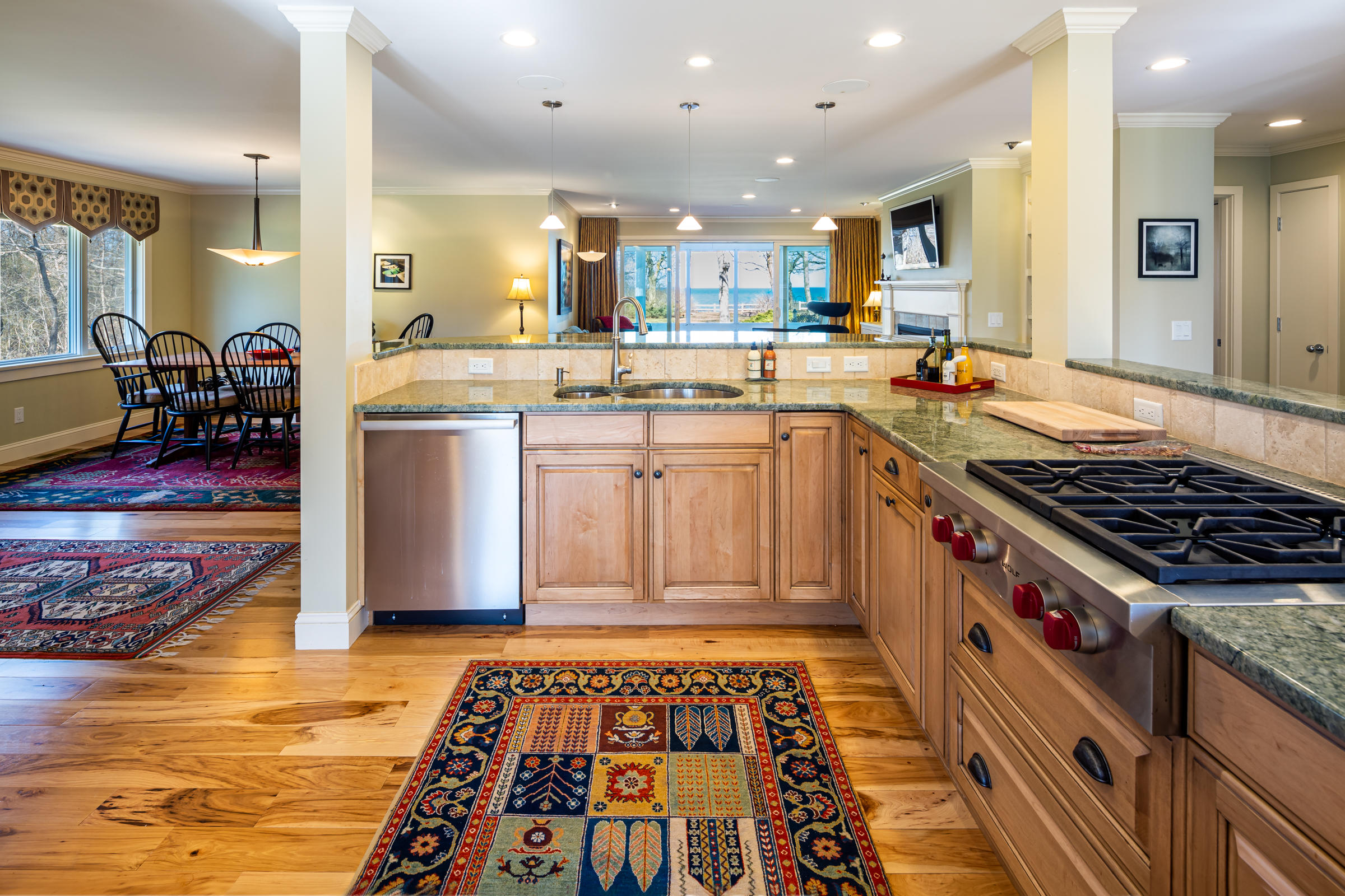 31 Wheeler Drive Brewster, MA 02631 - Photo 14 of 39 a kitchen with stainless steel appliances granite countertop a stove top oven a sink dishwasher and cabinets with wooden floor