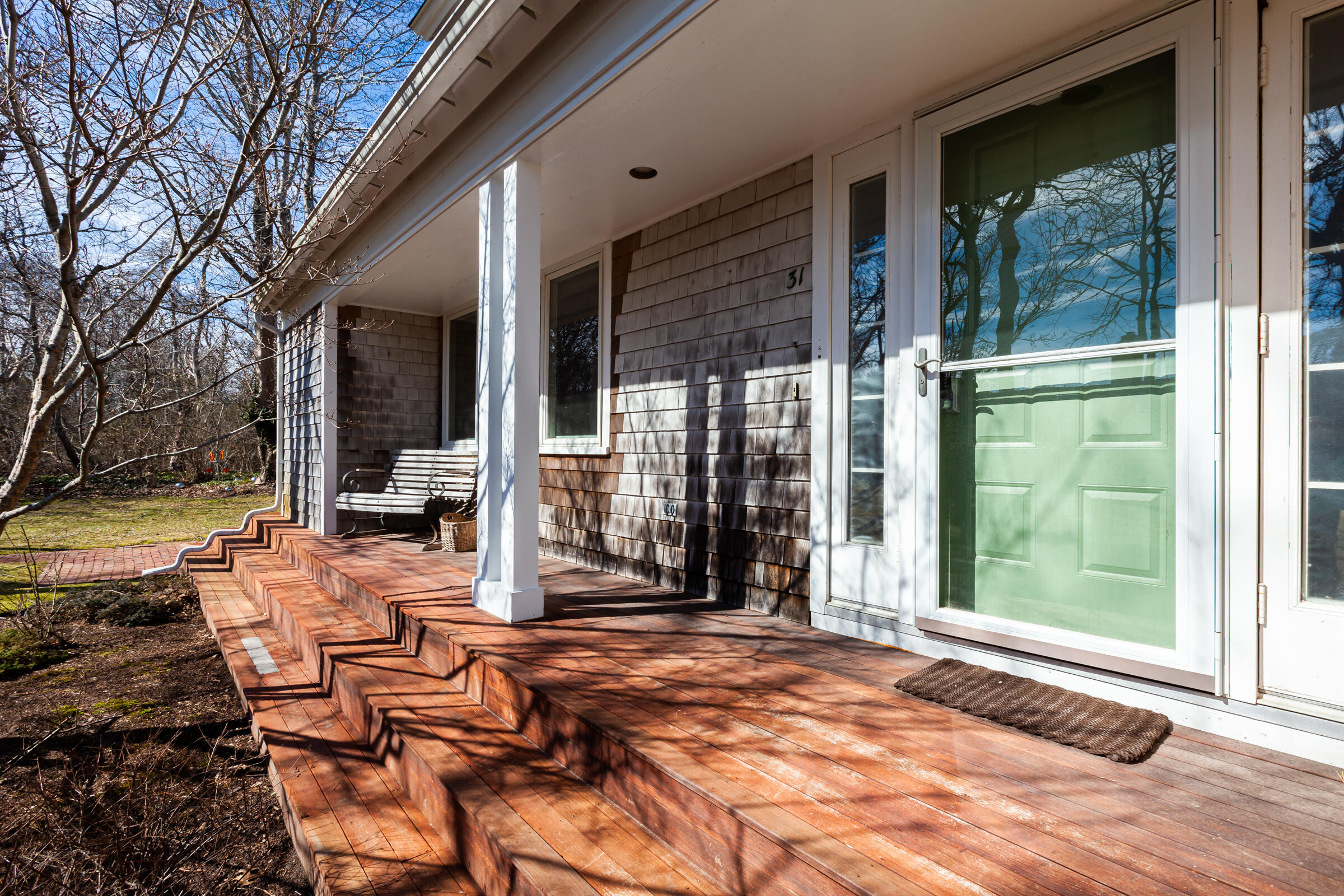 31 Wheeler Drive Brewster, MA 02631 - Photo 2 of 39 a view of a patio with table and chairs next to a yard