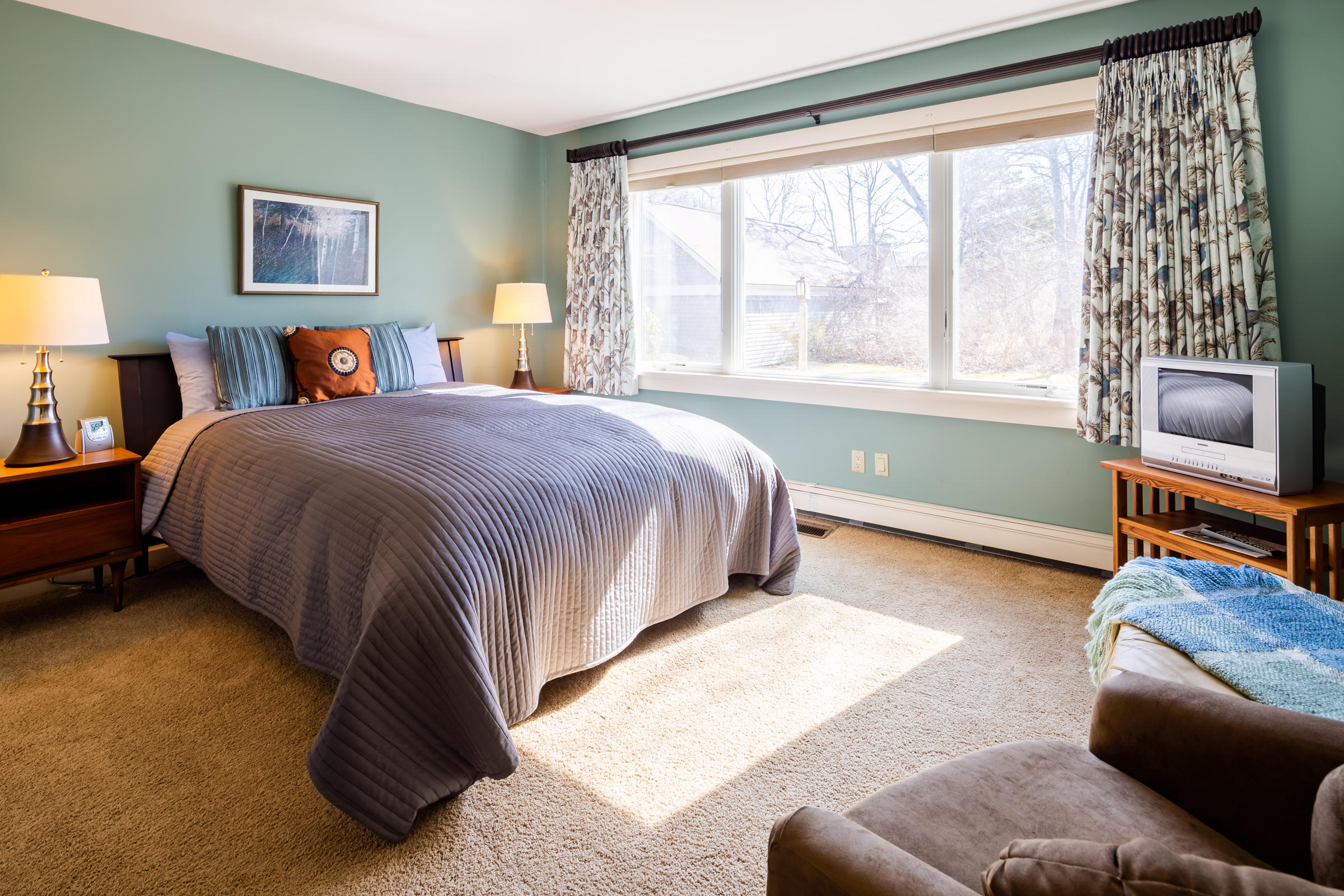 31 Wheeler Drive Brewster, MA 02631 - Photo 31 of 39 a bedroom with a bed and a couch next to a window