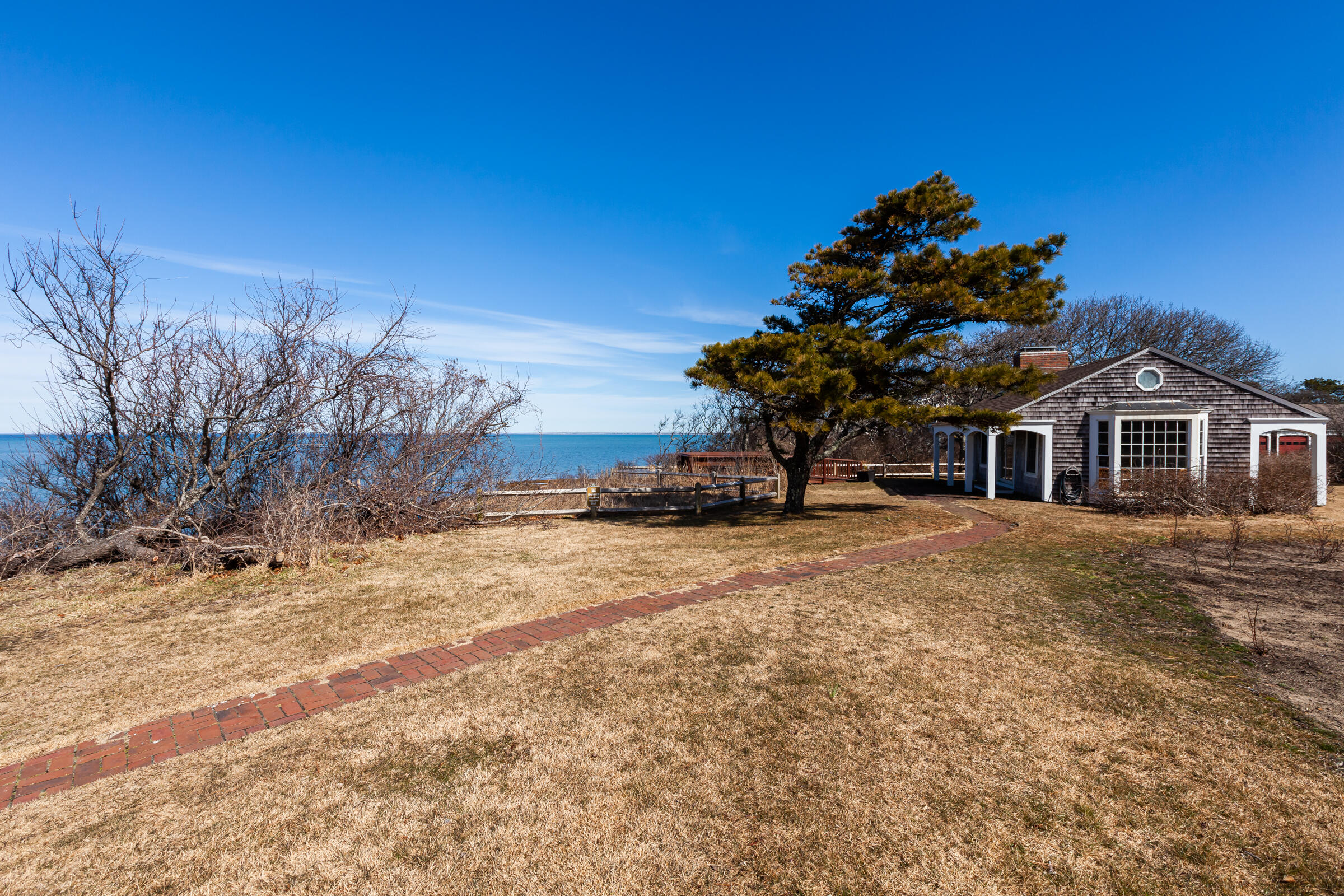 31 Wheeler Drive Brewster, MA 02631 - Photo 6 of 39 a front view of a house with a yard and garage