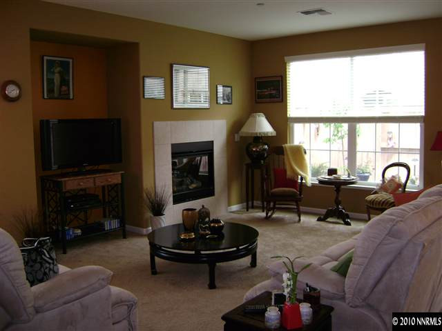 1924 A Wind Ranch Road Reno, NV 89521 - Photo 3 of 9 a living room with furniture a fireplace and a flat screen tv