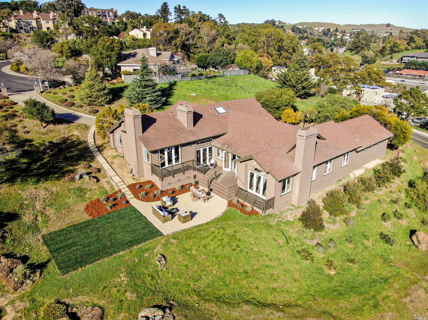 an aerial view of a house with garden space and street view