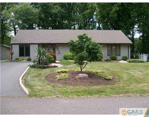 a view of a house with yard and tree s