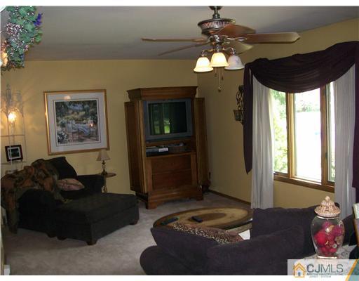21 Maida Road Edison, NJ 08820 - Photo 4 of 10 a living room with furniture and a chandelier