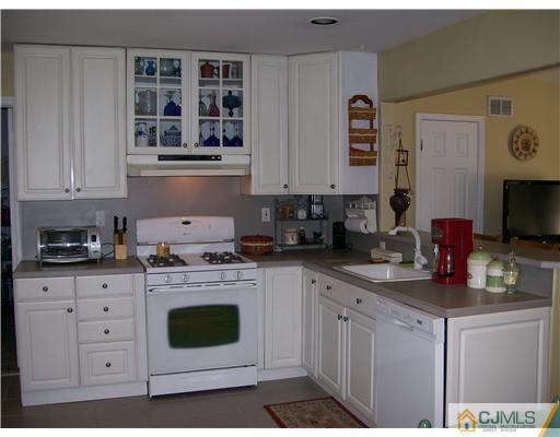 21 Maida Road Edison, NJ 08820 - Photo 6 of 10 a kitchen with cabinets appliances a sink and a counter top