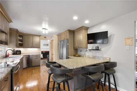 a kitchen with a table chairs refrigerator and microwave