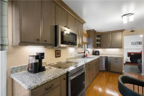a kitchen with a sink stove and cabinets