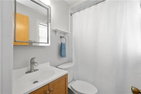 a bathroom with a sink a toilet and mirror