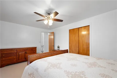 a bedroom with a large bed and a chandelier