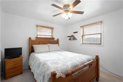 a bedroom with a bed and a tv