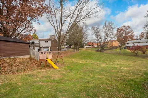 a view of a playground with a tree