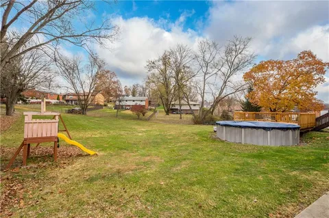 a view of a swimming pool with a yard