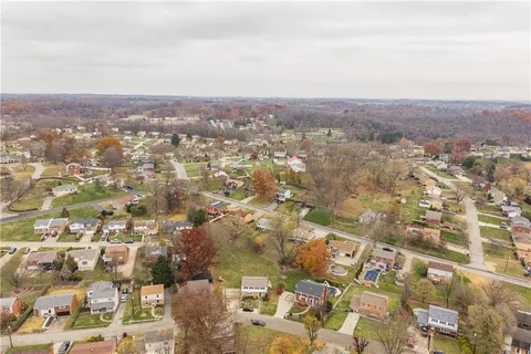 an aerial view of residential building with green space