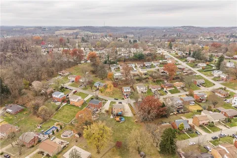 an aerial view of residential houses with city view