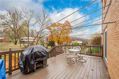 a view of a balcony with chairs and wooden floor