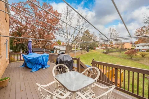 a view of a chair and tables on the roof deck