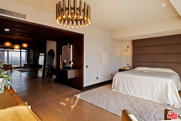 a bedroom with a large bed and a large window