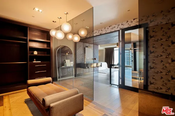 a living room with furniture a large window and chandelier