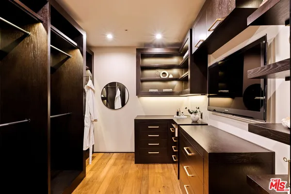 a bathroom with double vanity and a mirror