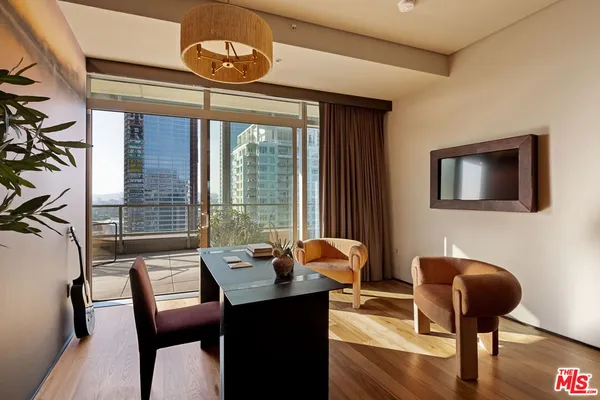 a room with a table chairs and wooden floor